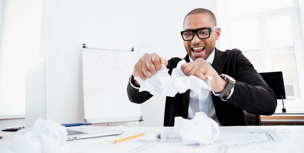 Man ripping up papers