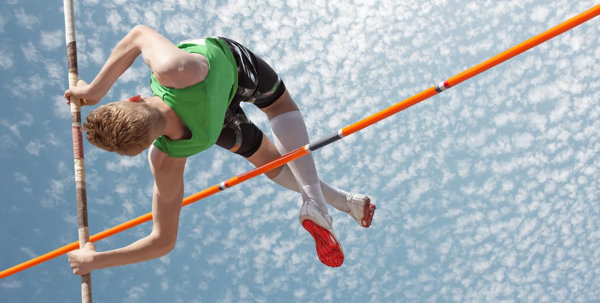 Pole vaulter clearing the bar