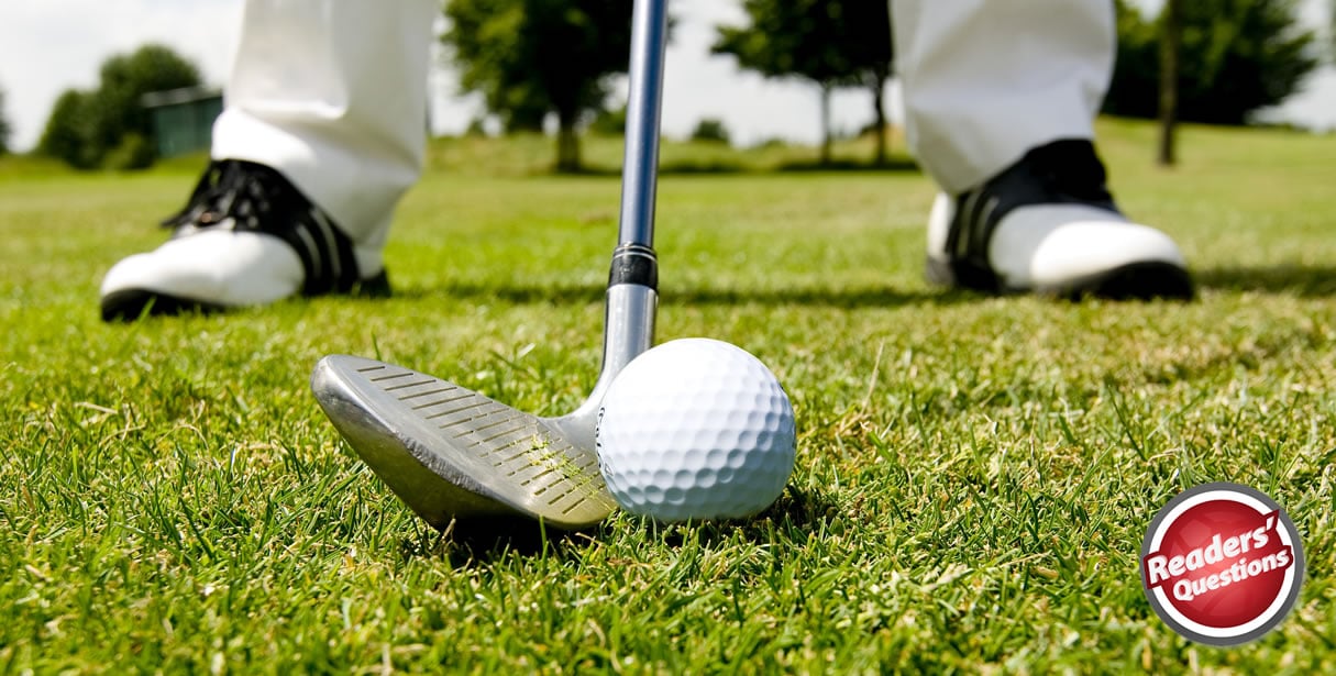 Golfer taking a shot on course