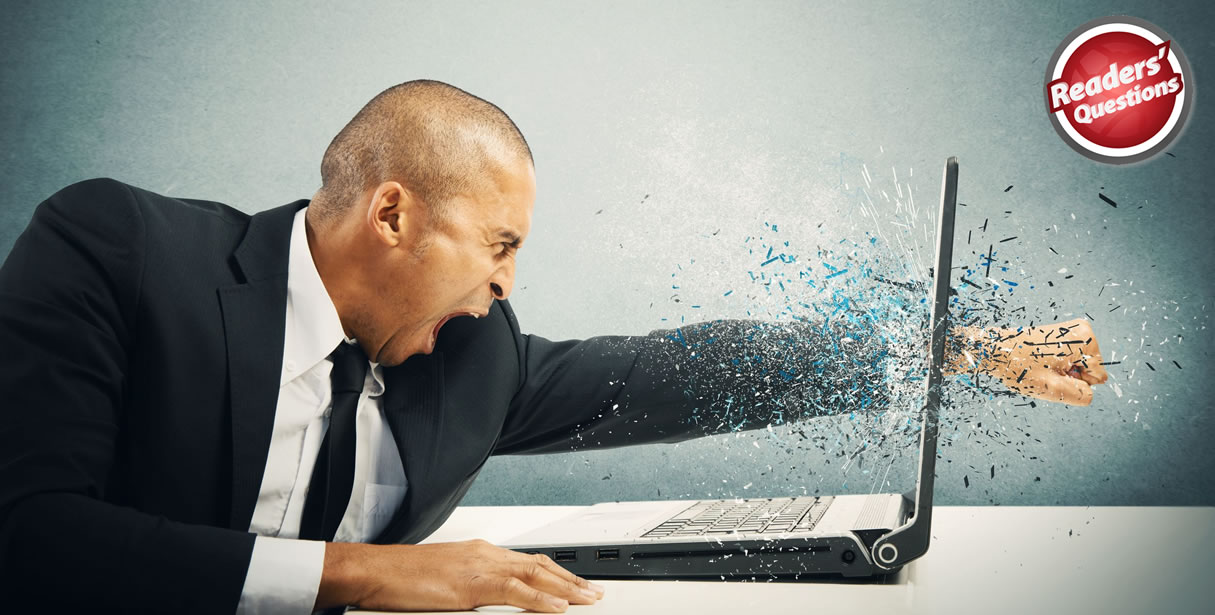 Angry man smashing laptop