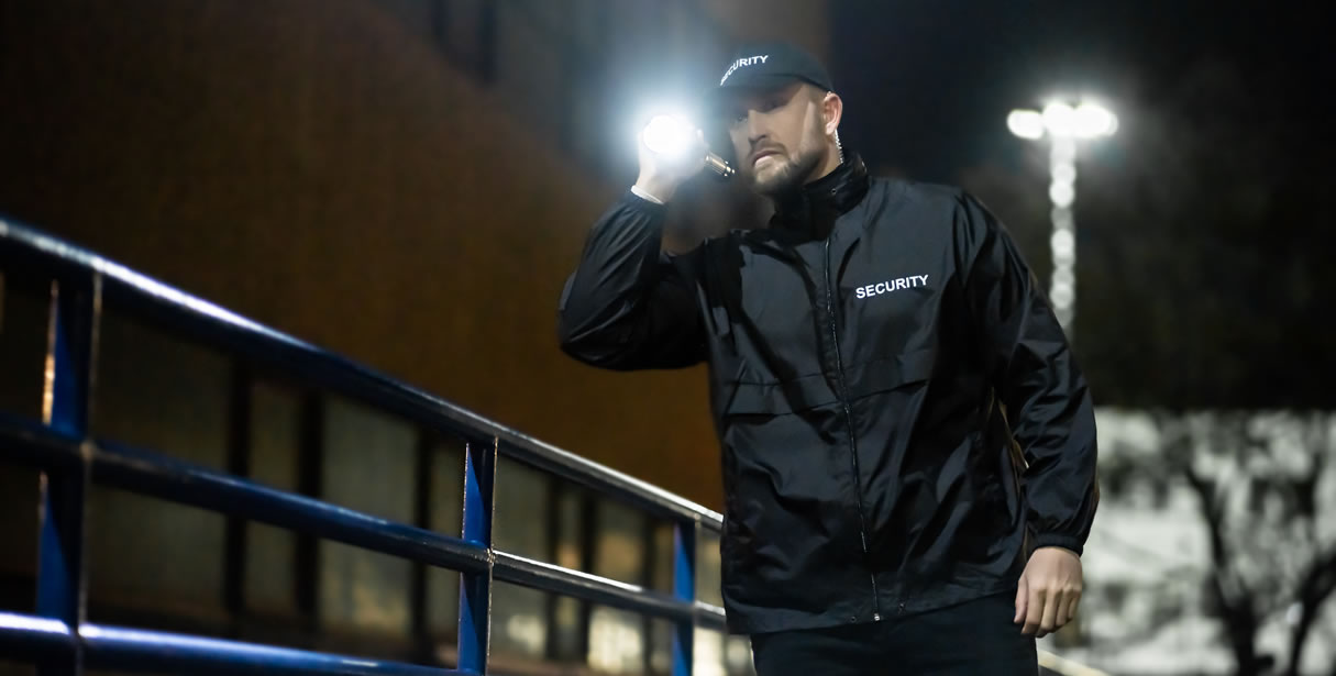 Security guard shining torch