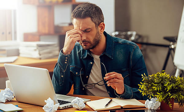 Tired man working at desk