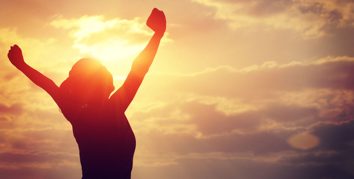 Woman celebrating sunrise