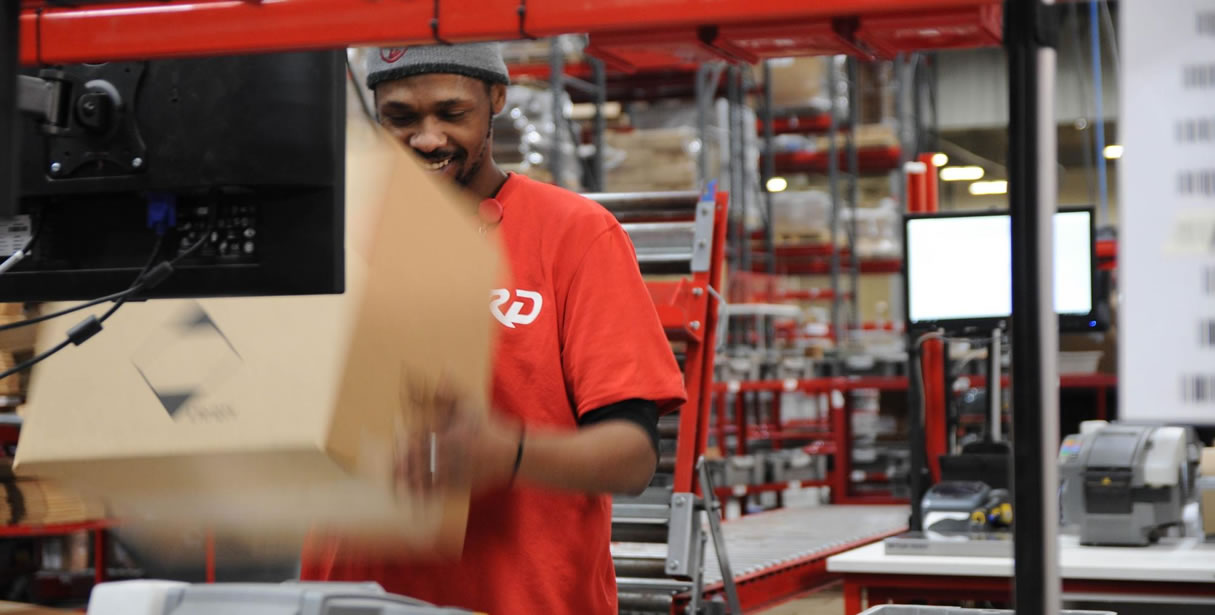 Man lifting box at fulfillment center