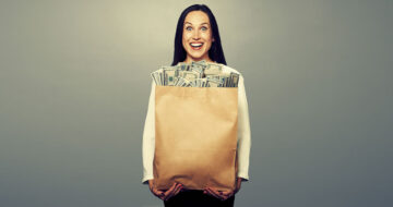 Woman holding bags of money