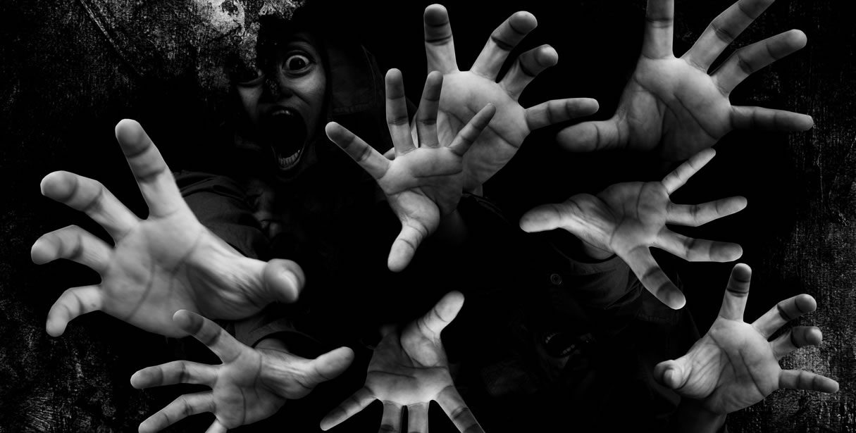 Hands reaching out of the darkness