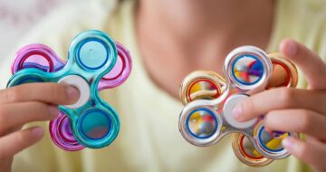 Boy holding fidget spinners