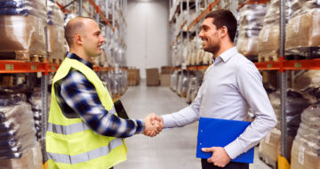 Men shaking hands in warehouse