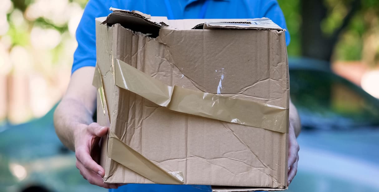 Delivery man handing over damaged parcel
