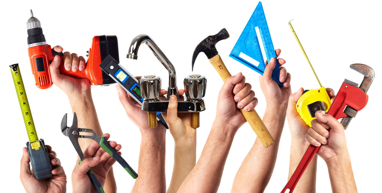 Hands holding construction tools