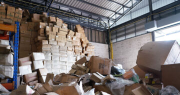 Warehouse with towers of toppling boxes