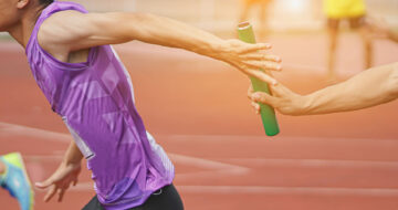 Runners passing a baton