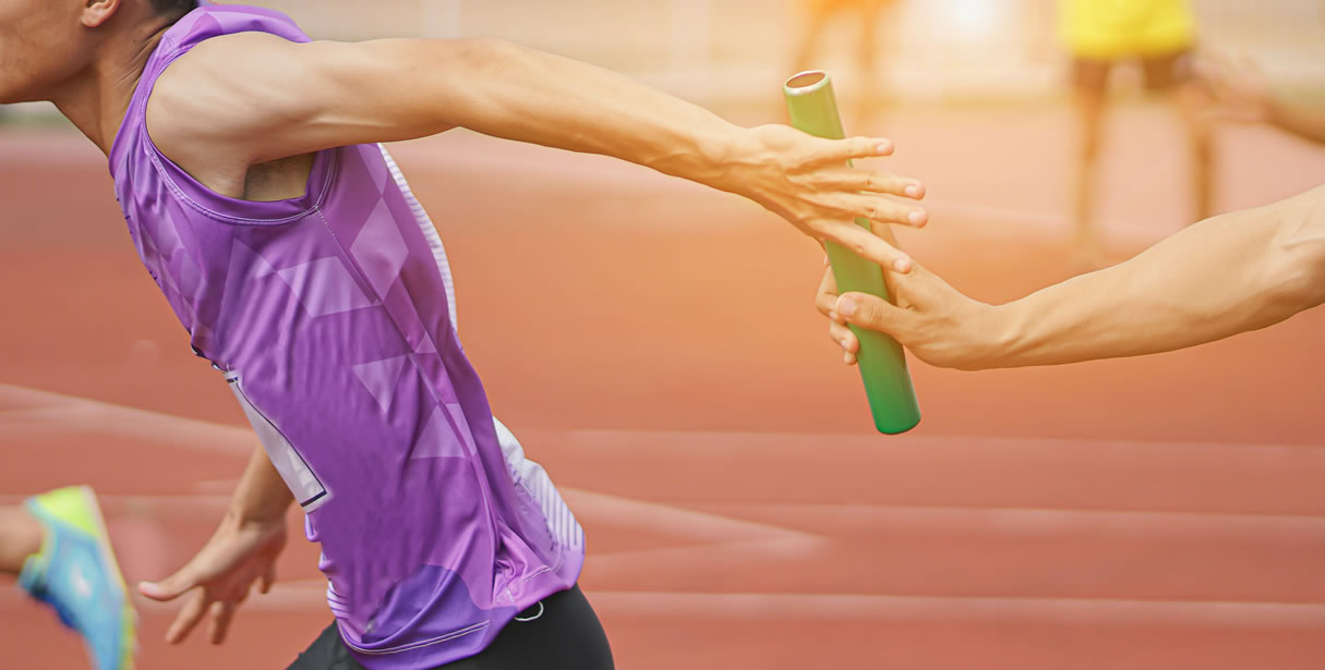Runners passing a baton