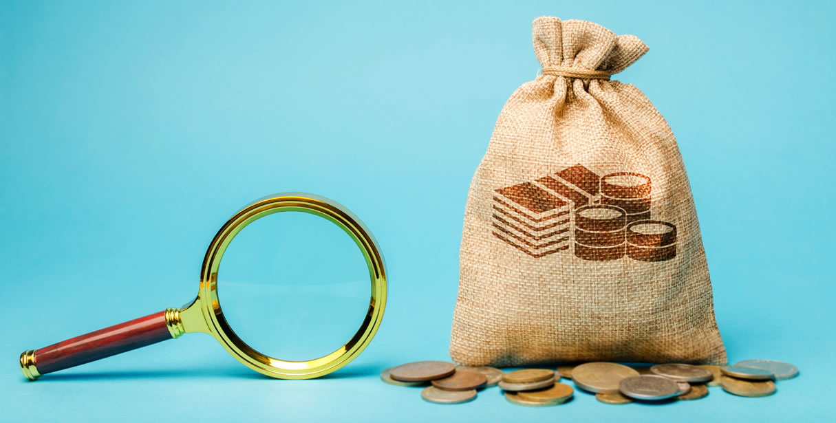 Magnifying glass and bag of money